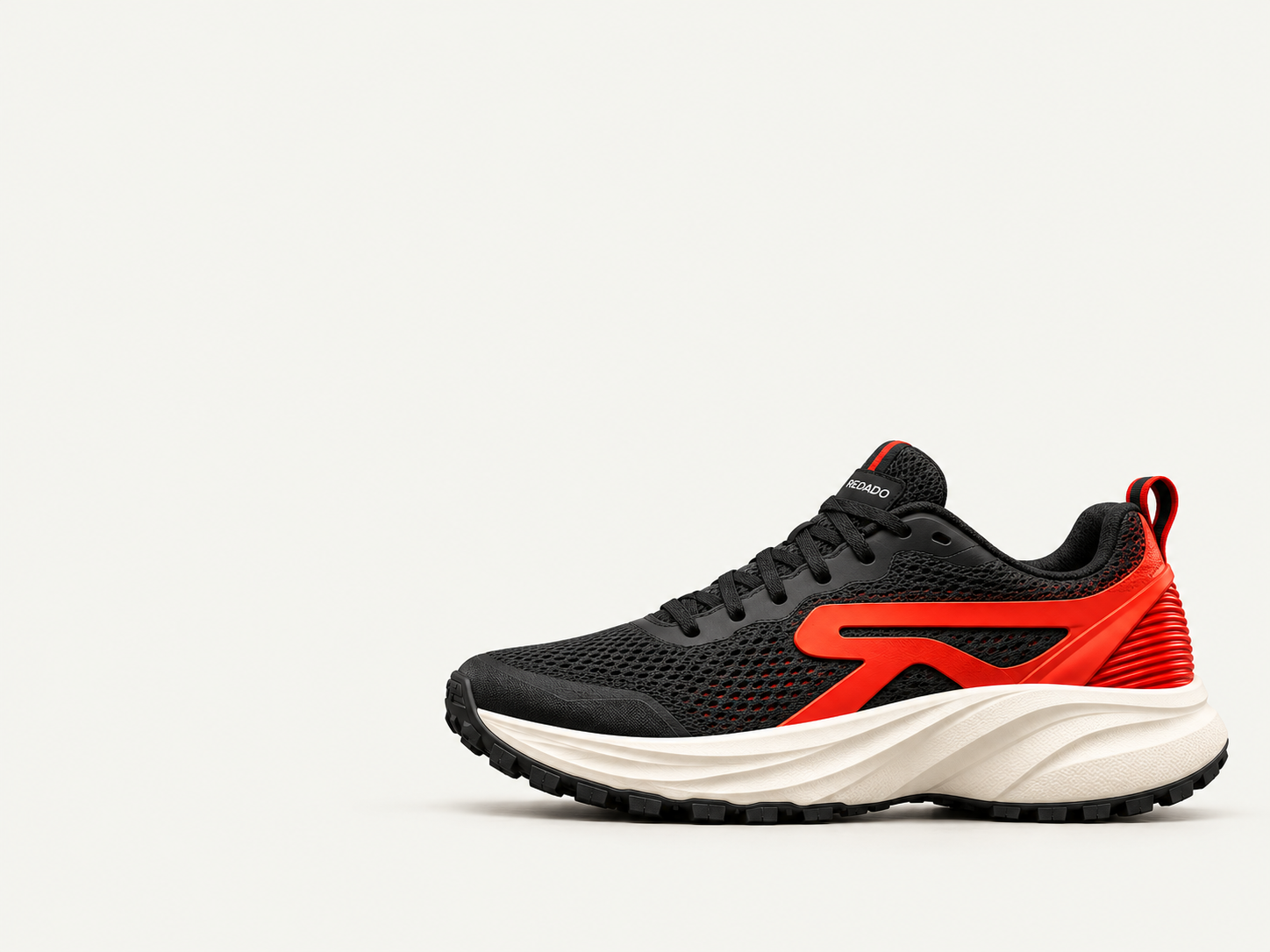Illustrative REDADO Daily black and red shoe on a light studio background.